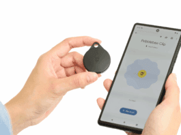 Hand holding Pebblebee Clip, a Bluetooth tracker with safety features
