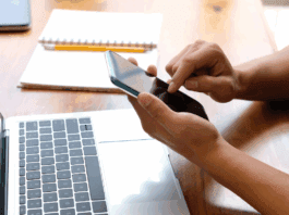 A person organizing apps and files on a smartphone and laptop to declutter their digital life.